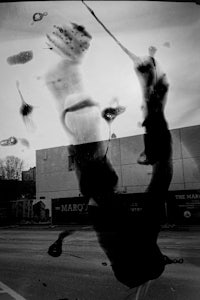 a black and white photo of a person jumping in the air